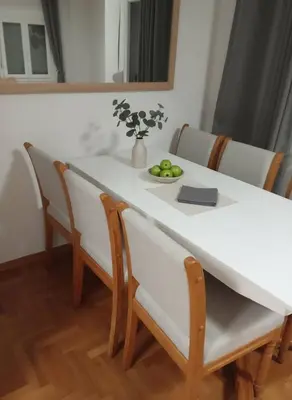 a white table with chairs and a vase of fruit on it at Athens Central Gem 2-Bedroom Retreat in Athens