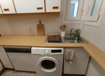 a kitchen with a washing machine and a sink at Athens Central Gem 2-Bedroom Retreat in Athens