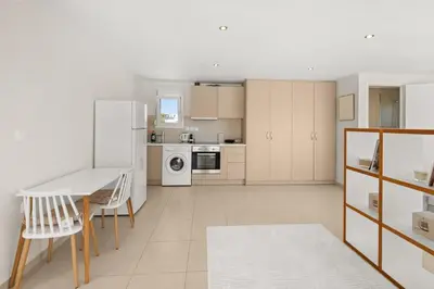 a kitchen with a table and chairs and a refrigerator at Apt 1' From The Sea With Private Terrace & BBQ in Vari