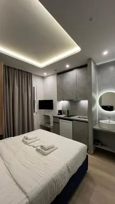 a bedroom with a bed with two towels on it at ERIFILI -mini apartment in Athens