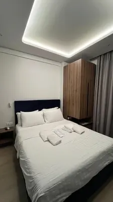 a bedroom with a large bed with two towels on it at ERIFILI -mini apartment in Athens