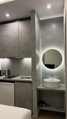 a bathroom with a sink and a mirror at ERIFILI -mini apartment in Athens
