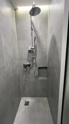 a bathroom with a shower with a shower head at ERIFILI -mini apartment in Athens