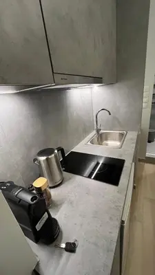 a kitchen counter top with a sink and a sink at ERIFILI -mini apartment in Athens