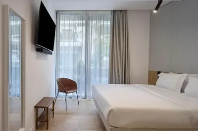 a hotel room with a bed and a television at Charitos Luxury Hideaway 2bd Apt in Kolonaki in Athens