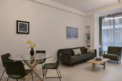 a living room with a couch and a glass table at Charitos Luxury Hideaway 2bd Apt in Kolonaki in Athens