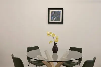 a dining room with a glass table and green chairs at Charitos Luxury Hideaway 2bd Apt in Kolonaki in Athens