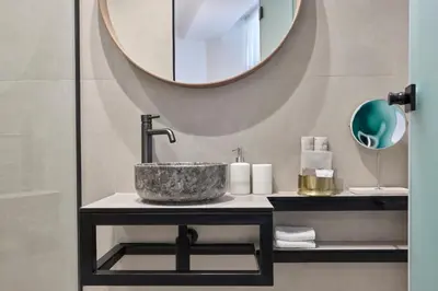a bathroom with a sink and a mirror at Charitos Luxury Hideaway 2bd Apt in Kolonaki in Athens