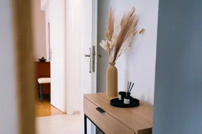 a vase with flowers in it sitting on a table at Comfy stay 2BR flat 1Gbps 4 min walk from metro in Athens