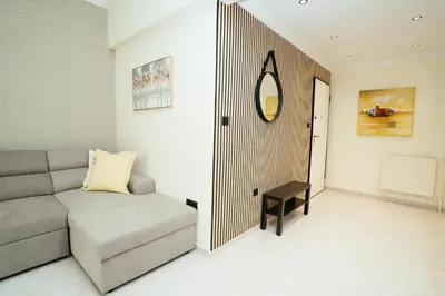 a living room with a couch and a table at Comfy stay 2BR flat 1Gbps 4 min walk from metro in Athens