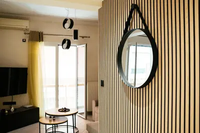 a living room with a mirror and a table at Comfy stay 2BR flat 1Gbps 4 min walk from metro in Athens
