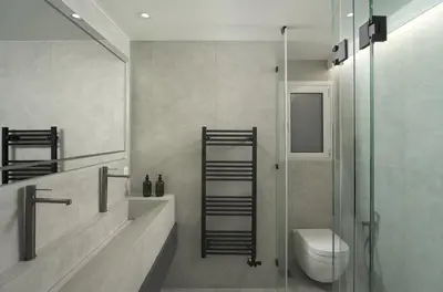 a bathroom with a toilet and a glass shower at Metro Acropolis, 117sqm luxury 3BDR, SuperViewAthens in Athens