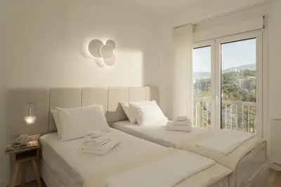 two beds in a white room with a window at Metro Acropolis, 117sqm luxury 3BDR, SuperViewAthens in Athens