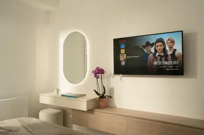 a bedroom with a flat screen tv on a wall at Metro Acropolis, 117sqm luxury 3BDR, SuperViewAthens in Athens