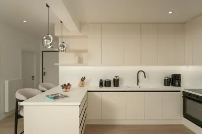 a white kitchen with white cabinets and a sink at Metro Acropolis, 117sqm luxury 3BDR, SuperViewAthens in Athens
