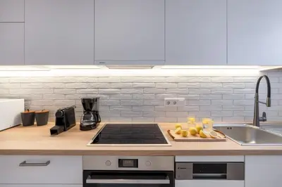 a kitchen with a sink and a stove top oven at Family-Friendly Thisseio Retreat Near Acropolis in Athens