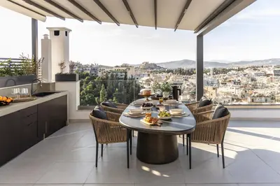 a kitchen and dining room with a table and chairs at Urban Forty One Acropolis-view penthouse in Athens