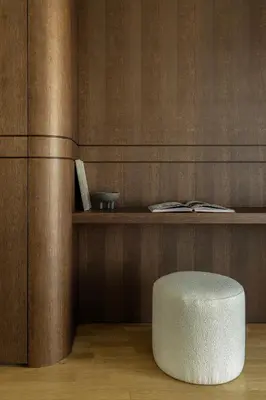 a white stool sitting in front of a wooden wall at Urban Forty One Acropolis-view penthouse in Athens