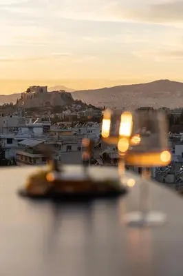 a view of a city with a boat in the water at Urban Forty One Acropolis-view penthouse in Athens