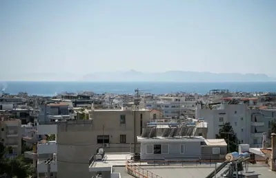 a view of a city with buildings and the ocean at Glyfada Residence Top Floor With Sea & Tower View in Athens