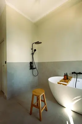 a bathroom with a white tub and a stool at Mosaics Agora Boutique Hotel in Athens