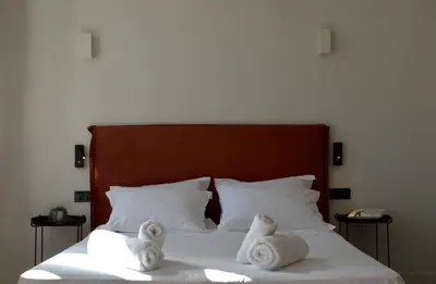 two towels on a bed with two pillows at Mosaics Agora Boutique Hotel in Athens