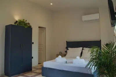 a bedroom with a bed with two white pillows at Mosaics Agora Boutique Hotel in Athens