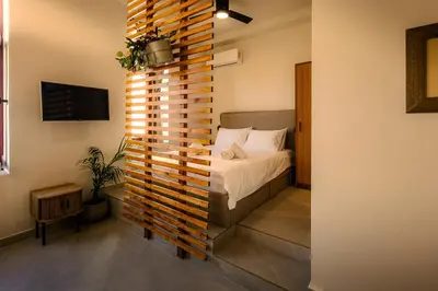 a bedroom with a bed with a wooden wall at Mosaics Agora Boutique Hotel in Athens
