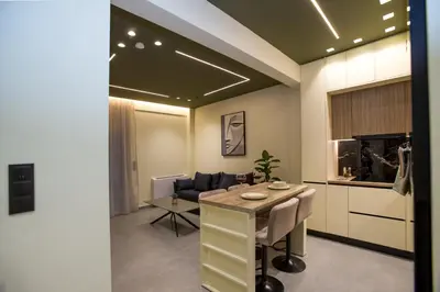 a living room with a table and a couch at Luxury apartments near athens city center in Athens