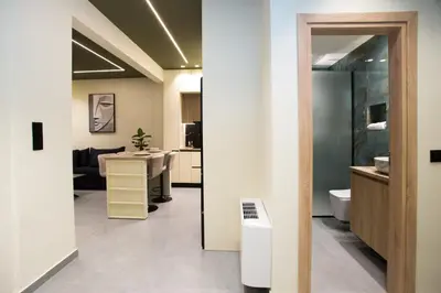 a bathroom with a sink and a toilet in a room at Luxury apartments near athens city center in Athens