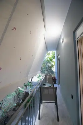 an attic room with a staircase and a table at Luxury apartments near athens city center in Athens