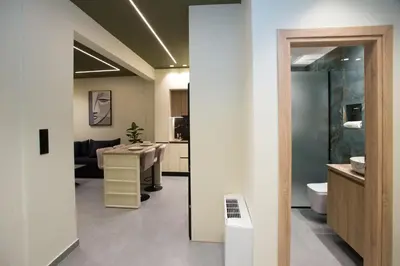 a bathroom with a sink and a toilet in a room at Luxury apartments near athens city center in Athens