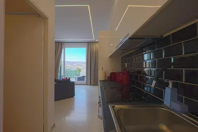 a kitchen with a sink and a view of a living room at Piraeus Harbor Hideaway in Piraeus