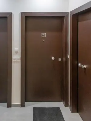 a brown door with the number on it at Athenian Nest Studio by WeHost Athens in Athens