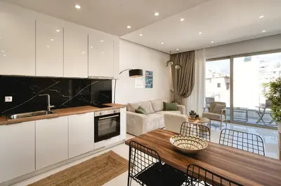 a kitchen and living room with a table at Artemis House Athens in Athens