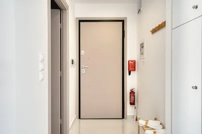 a hallway with a large door in a room at Artemis House Athens in Athens