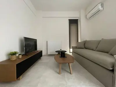 a living room with a couch and a table at Cityscape Brand New Flat in Athens