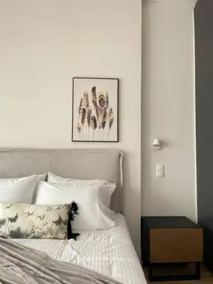 a bedroom with a white bed with a nightstand next to it at Cityscape Brand New Flat in Athens