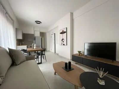 a living room with a couch and a flat screen tv at Cityscape Brand New Flat in Athens