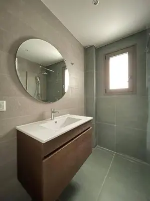 a bathroom with a sink and a mirror at Cityscape Brand New Flat in Athens