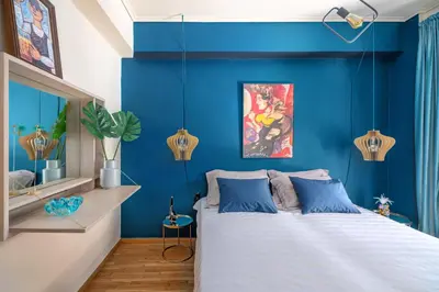 a bedroom with blue walls and a bed at Urban Νest in Athens next to Caravel in Athens