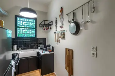a kitchen with a sink and utensils on the wall at Urban Νest in Athens next to Caravel in Athens