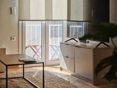a living room with a table and a television at Real Athens K17 in Athens