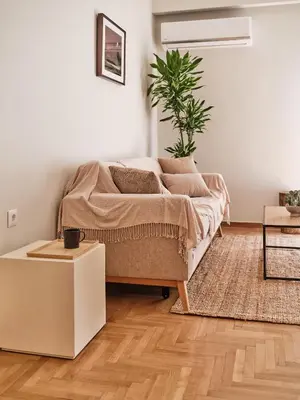 a living room with a couch and a potted plant at Real Athens K17 in Athens