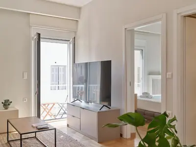 a living room with a tv and a table at Real Athens K17 in Athens