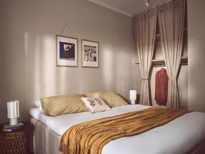 a bedroom with a bed with a blanket on it at Melpomeni House in Athens