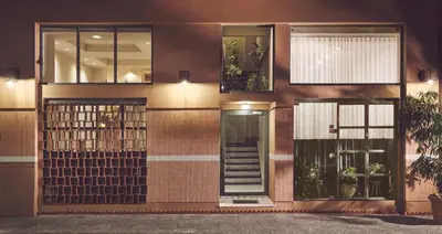 a facade of a building with a glass door at Melpomeni House in Athens