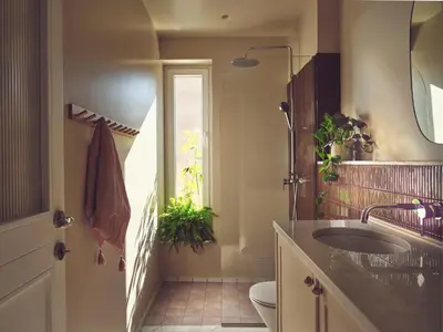 a bathroom with a sink and a toilet and a window at Melpomeni House in Athens
