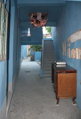 a hallway with blue walls and a staircase with a desk at Back to the 50's near metro by Traser in Athens