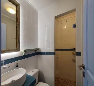 a bathroom with a sink and a toilet and a mirror at Back to the 50's near metro by Traser in Athens